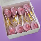 Box of Pink Cake Pops with letter 'M' and white stars.