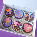 Decorative biscuits with colourful icing in a box.