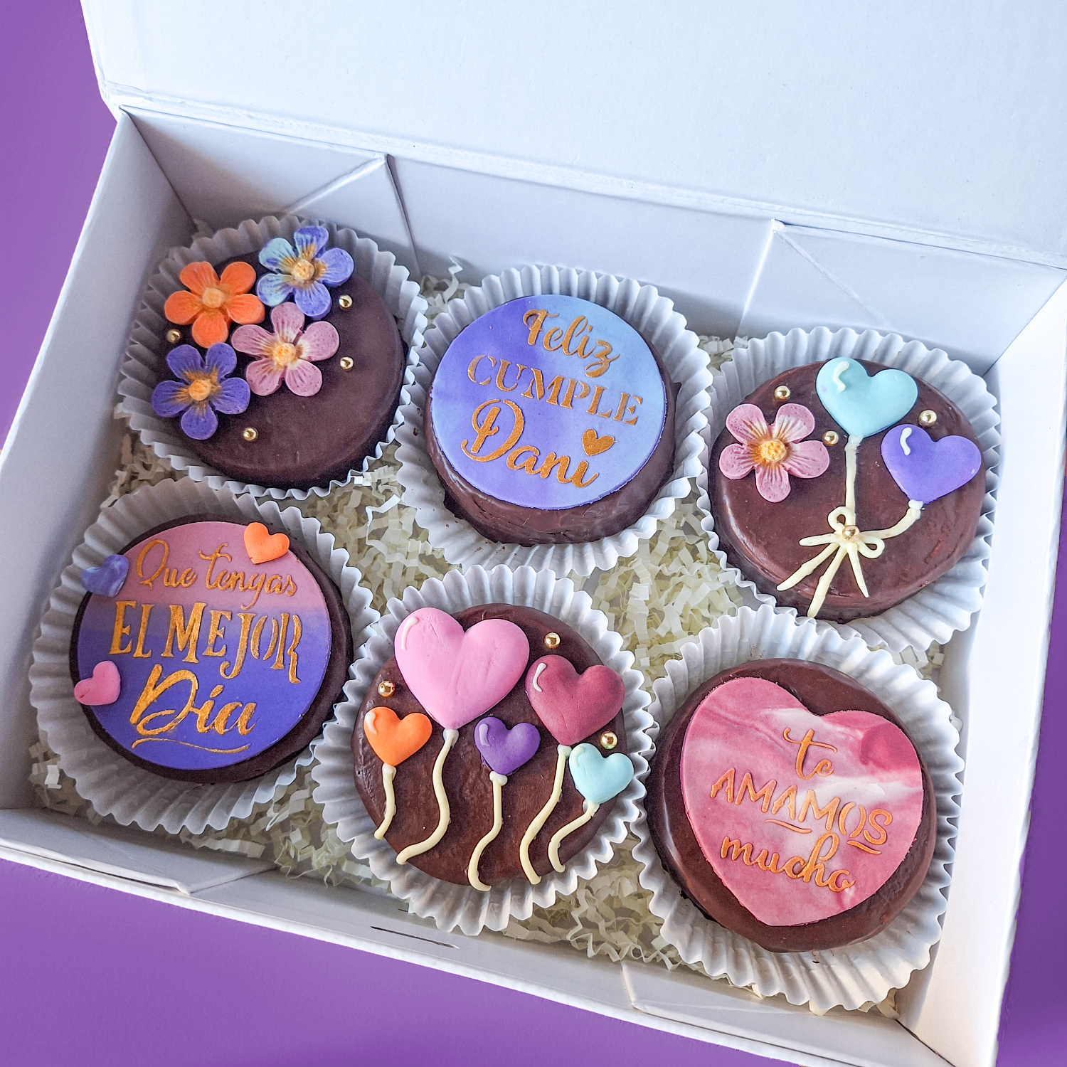 Decorative biscuits with colourful icing in a box.