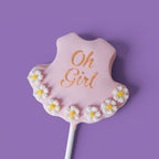 First Cake Pops with baby girl shower themed text " Oh Girl" and daisies flower designs.