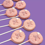 Pink Rounded shape Cake Pops with star and Letter "K" decorations.